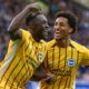 Danny Welbeck celebrates scoring Brighton's second goal with Joao Pedro