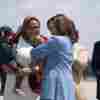 Vice President Harris holds the baby of Durham County Board of Commissioners chair Nida Allam upon arrival at Raleigh-Durham International Airport in North Carolina on Aug. 16, 2024.