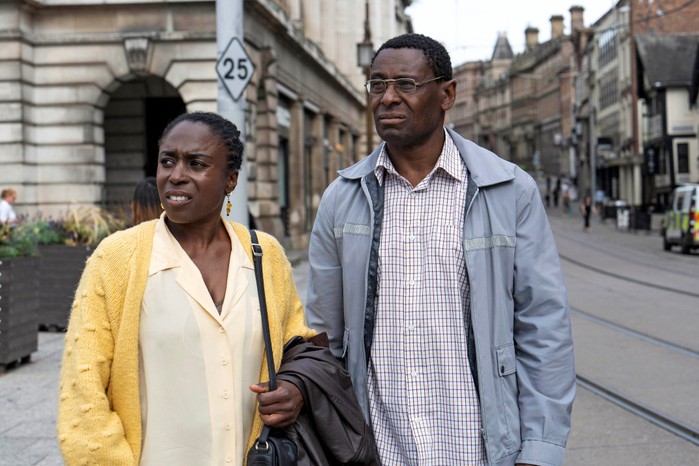 Sharlene Whyte as Pam Bottomley and David Harewood as Denis Bottomley in Sherwood season 2 standing in the middle of a city centre and looking confused at the other side of the road.