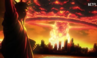 A massive mushroom cloud erupts behind the Statue of Liberty