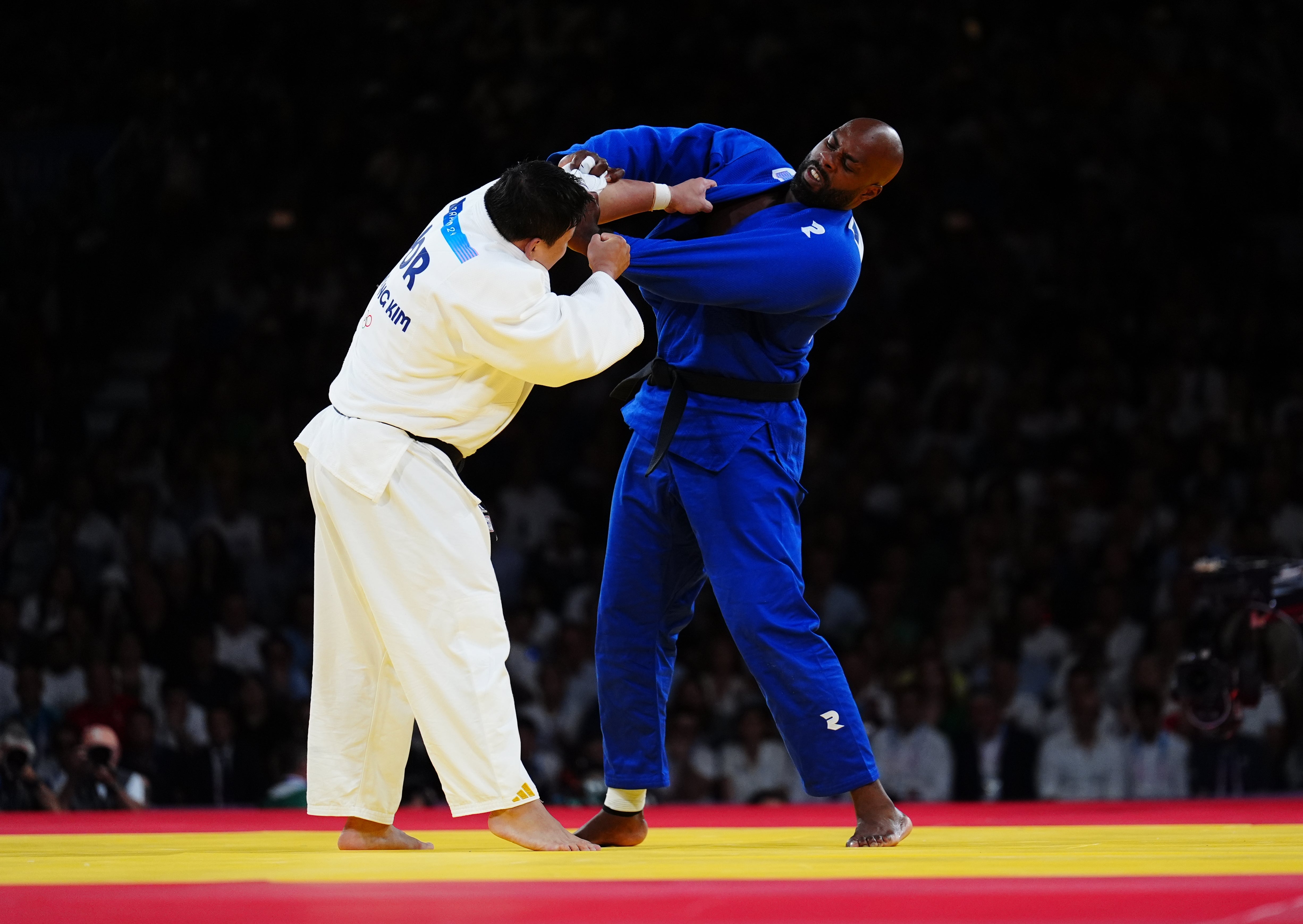 Teddy Riner, right, battles Korea’s Kim Min-jong