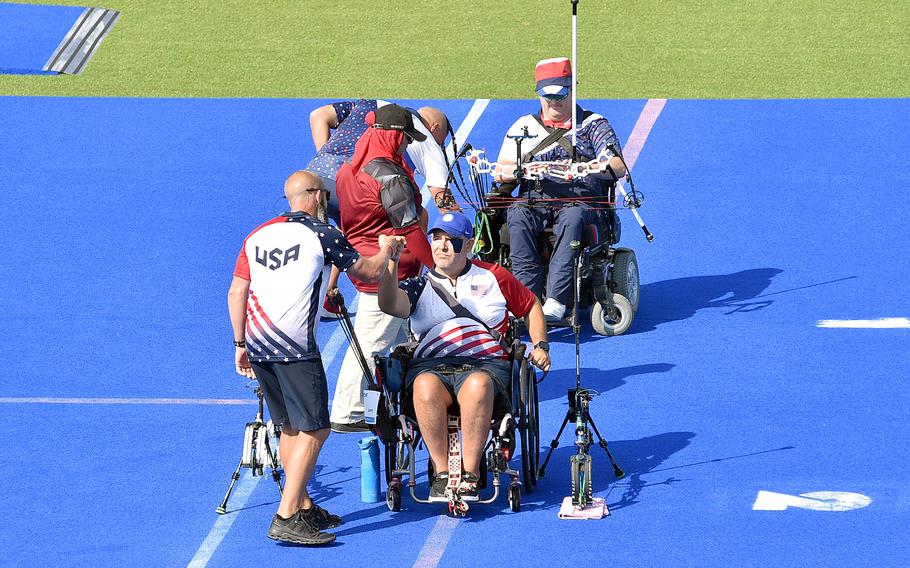 Army veteran Jason Tabansky fist-bumps his coach