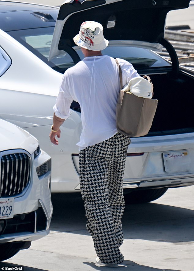 Brad looked relaxed and happy as he walked, with the star finishing off his travelling ensemble with a simple white top, dark sunglasses and trainers