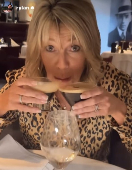 Ruth Langsford drinking two cocktails in a bar