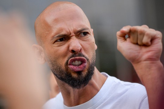 Andrew Tate gestures outside the Bucharest Tribunal after being placed under house arrest, in Bucharest, Romania, Thursday, Aug. 22, 2024. A court in Romania's capital on Thursday placed the divisive internet influencer Andrew Tate under house arrest for 30 days, as prosecutors investigate a sprawling new case that involves allegations of human trafficking of minors and sex with a minor. (AP Photo/Alexandru Dobre)