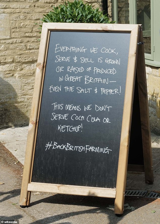 A board placed outside The Farmer's Dog stating that everything inside Jeremy's new pub is grown and raised in Great Britain