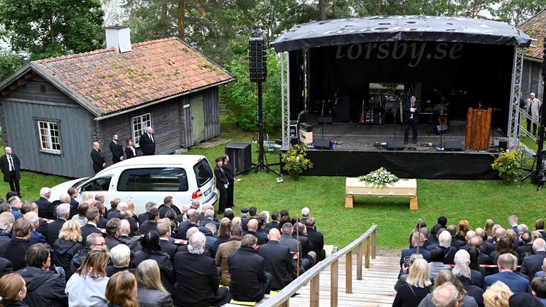 Eriksson's coffin and mourners at his wake at Torsby's homestead museum. Pic: Reuters