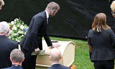 David Beckham touches Eriksson's coffin at the wake in Torsby. Pic: AP