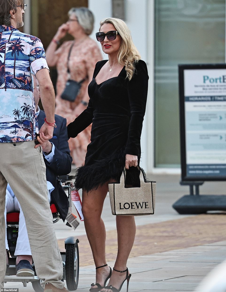 Katie cut a very glamorous appearance as she dressed to impress in a thigh-skimming dress complete with towering heels, shades and a designer bag