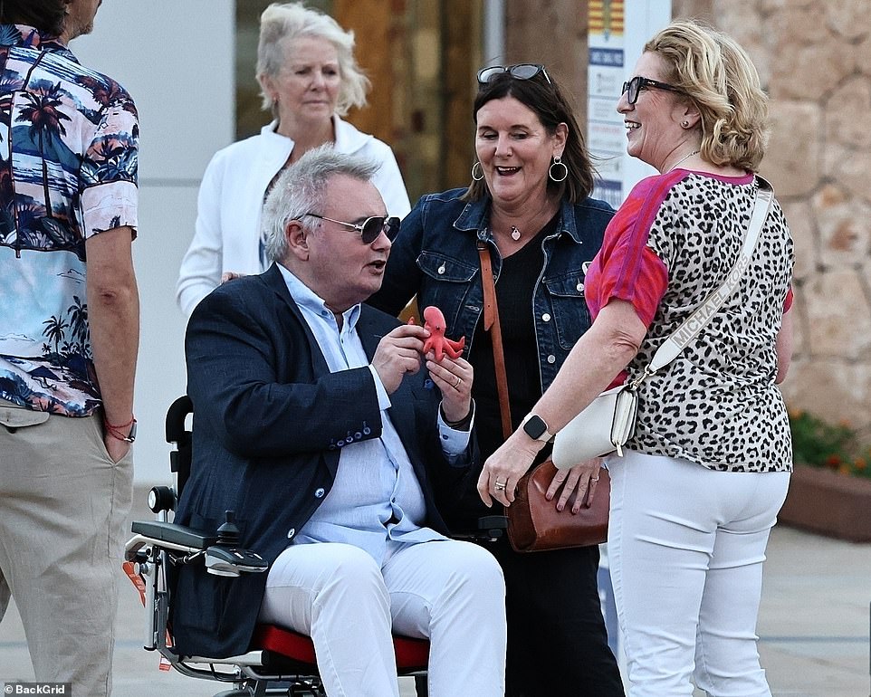 At one point he was bizarrely seen holding a toy octopus while chatting to admirers