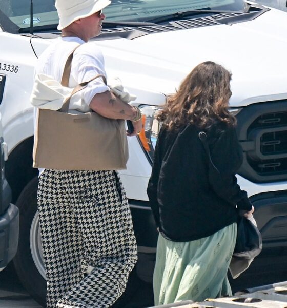 Brad Pitt ditched his sharp suits for a casual yet quirky ensemble as he touched down in Los Angeles on Monday following a whirlwind trip to Venice