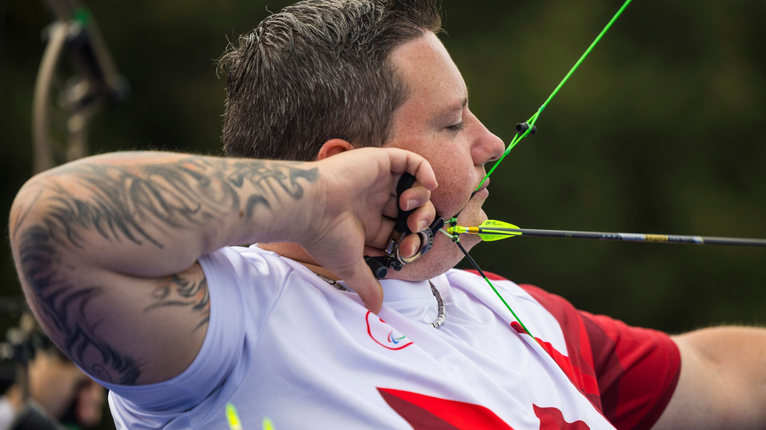 Kyle Tremblay pulls back an arrow preparing to shoot