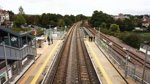 GWR An aerial shot of the new Ashley Down train station in Bristol, showing both platforms and the double train tracks stretching off into the distance