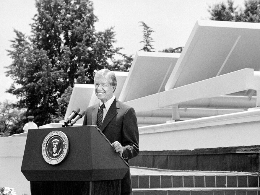 President Jimmy Carter speaks in front of solar panels placed on the West Wing roof of the White House on June 20, 1979. As the U.S. faced an energy crisis in the 1970s, Carter called for Americans to conserve energy and to expand the use of solar power.