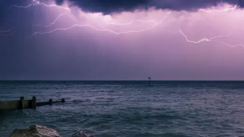 Getty Images A lightning storm over the English Channel at night viewed from the West Sussex coast.