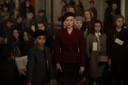 Saoirse Ronan in World War Two era clothing among a crowd in Blitz