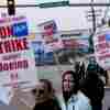 Boeing workers wave picket signs as they strike after union members voted to reject a contract offer, Sunday, Sept. 15, 2024, near the company's factory in Everett, Wash.