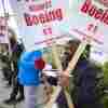 Boeing workers hold signs on the picket line at the Renton assembly plant on Friday in Renton, Wash.