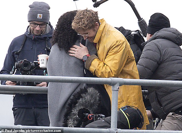 In the scenes, Ryan was seen holding a phone while he listened to something through a pair of wired earphones. He then was seen hugging his co-star, who is yet to be identified