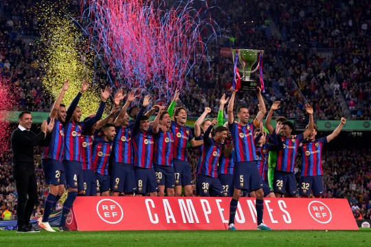 Sergio Busquets of FC Barcelona lifts the LaLiga Santander Trophy as players of FC Barcelona celebrate after being crowned League Champions after the LaLiga Santander match between FC Barcelona and Real Sociedad