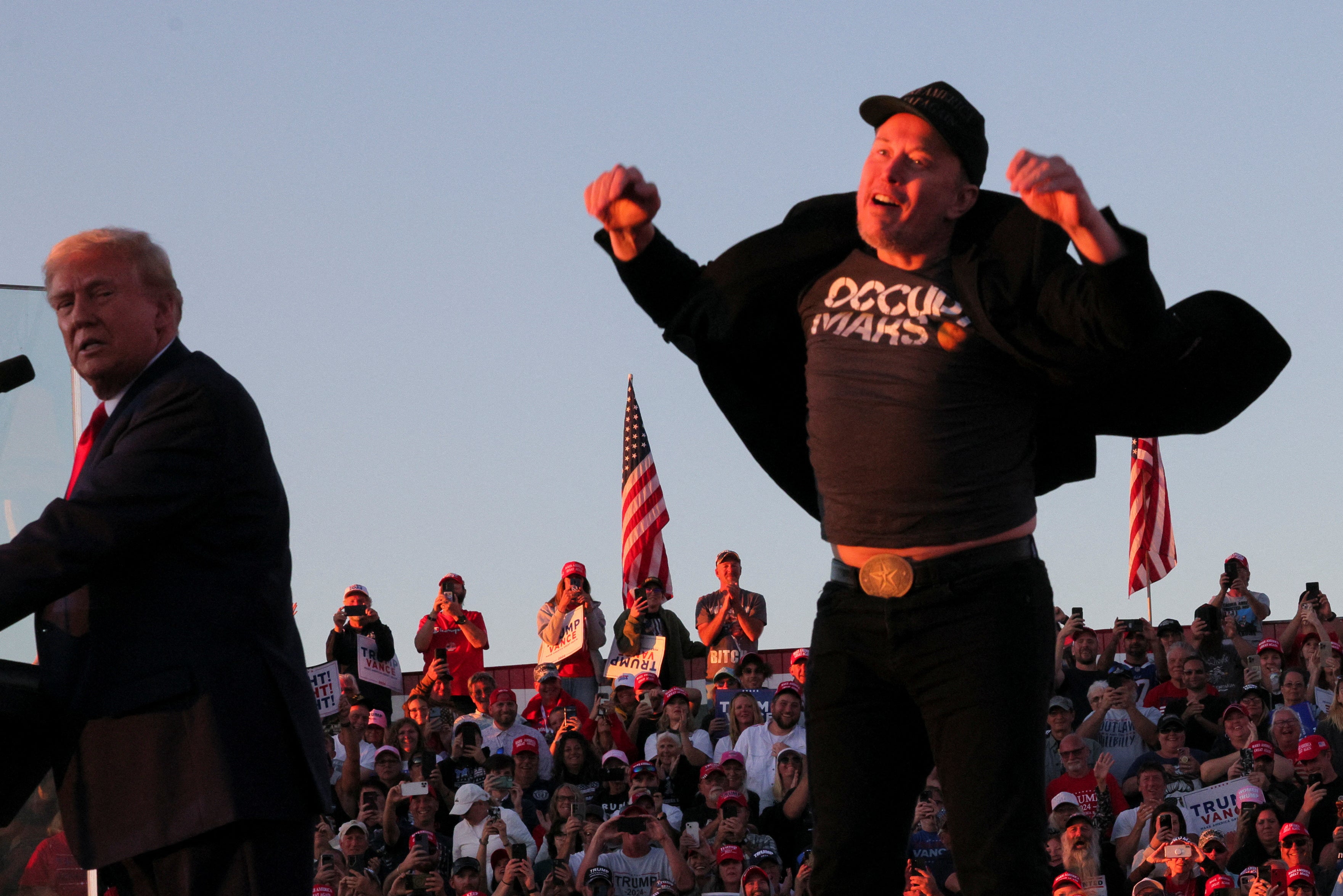 One picture from the event shows Elon Musk in the middle of a jaunty little half-hop while Trump looks on like a disappointed father