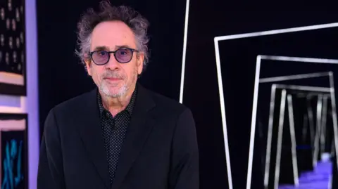 PA Tim Burton visits the new exhibition dedicated to his career at the Design Museum in London ahead of it opening to the public on Friday. 