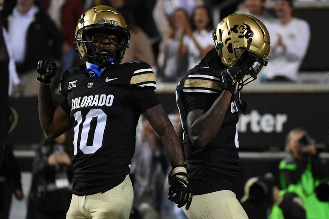 Sep 21, 2024; Boulder, Colorado, USA; Colorado Buffaloes wide receiver Omarion Miller (4) celebrates with wide receiver LaJohntay Wester (10) after a touchdown during the first half against the Baylor Bears at Folsom Field.