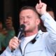 Tommy Robinson returns to UK after fleeing from England