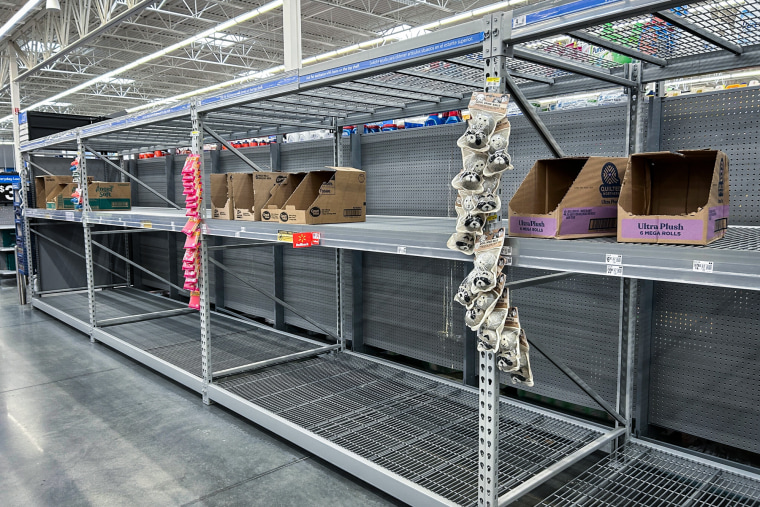 A store aisle with empty shelves