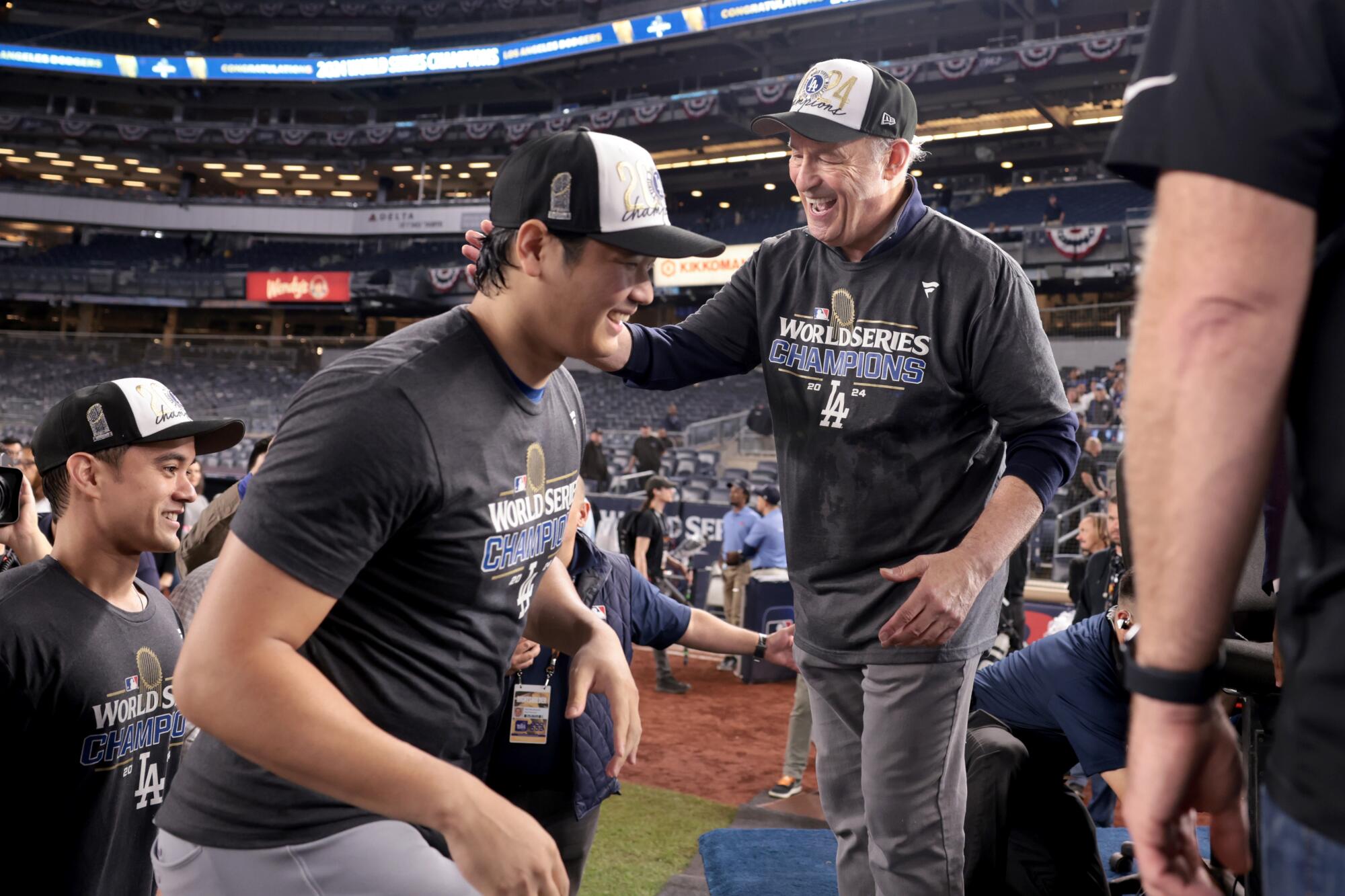 Dodgers president Stan Kasten, right, celebrates with Shohei Ohtani after the team's World Series win over the Yankees.