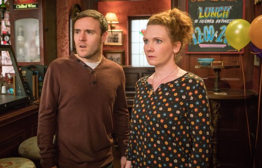 Alan Halsall looks shocked in character as Tyrone Dobbs, alongside Jennie McAlpine's character Fiz Dobbs, in the Rovers Return in Coronation Street