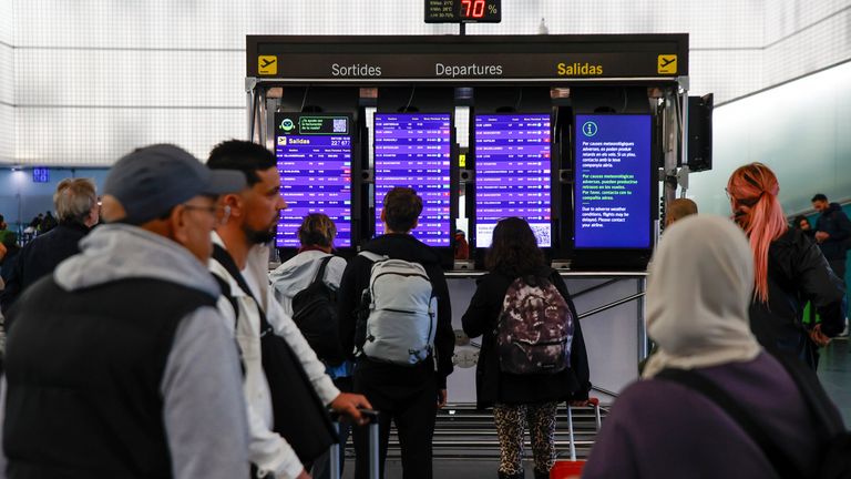 People check the departure board at Barcelona-El Prat airport as flights are diverted due to the weather.
Pic: Europa Press/AP