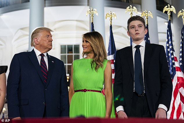 Barron, seen here in 2020, still towered over both of his parents, Melania and Donald