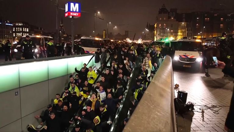 Police escort Maccabi Tel Aviv supporters inside Amsterdam's Centraal station on Thursday evening. Pic: AP