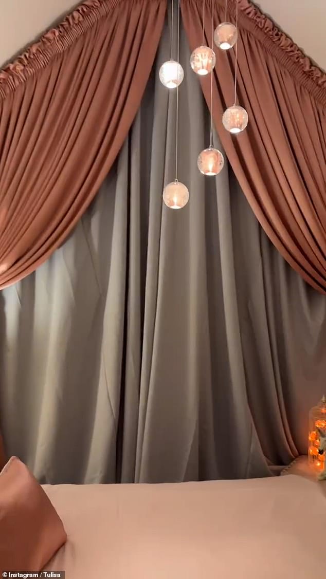 A pink glass chandelier hung from the ceiling which lit the room