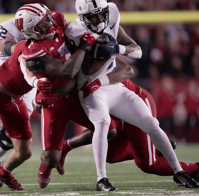 Wisconsin linebacker Jaheim Thomas (7) tackles Penn State running back Nicholas Singleton (10) during the second quarter of their game Saturday, October 26, 2024 at Camp Randall Stadium in Madison, Wisconsin.