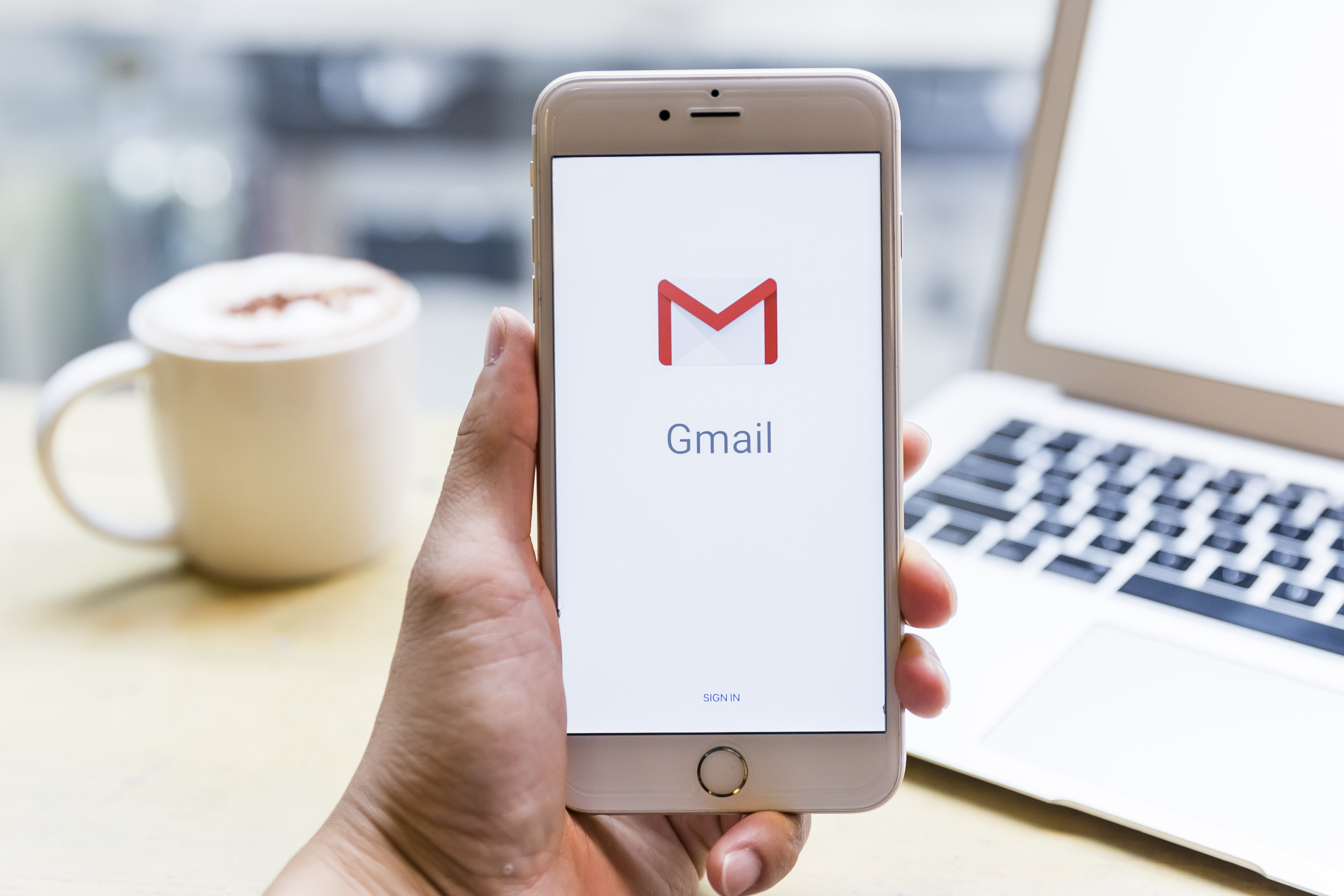 Stock image of Gmail logo on phone.