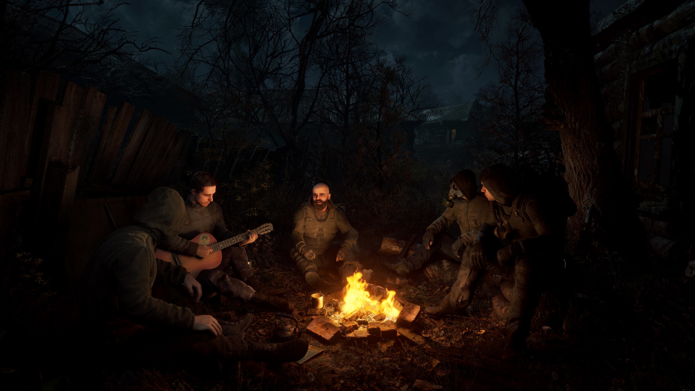 A group of STALKERs sit around the fire in STALKER 2. It is dark, and the fire is bright.