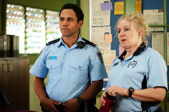 Aaron McGrath plays Felix Wilkinson and Celia Ireland plays Reggie Rocco, dressed in their police uniforms stood next to each other