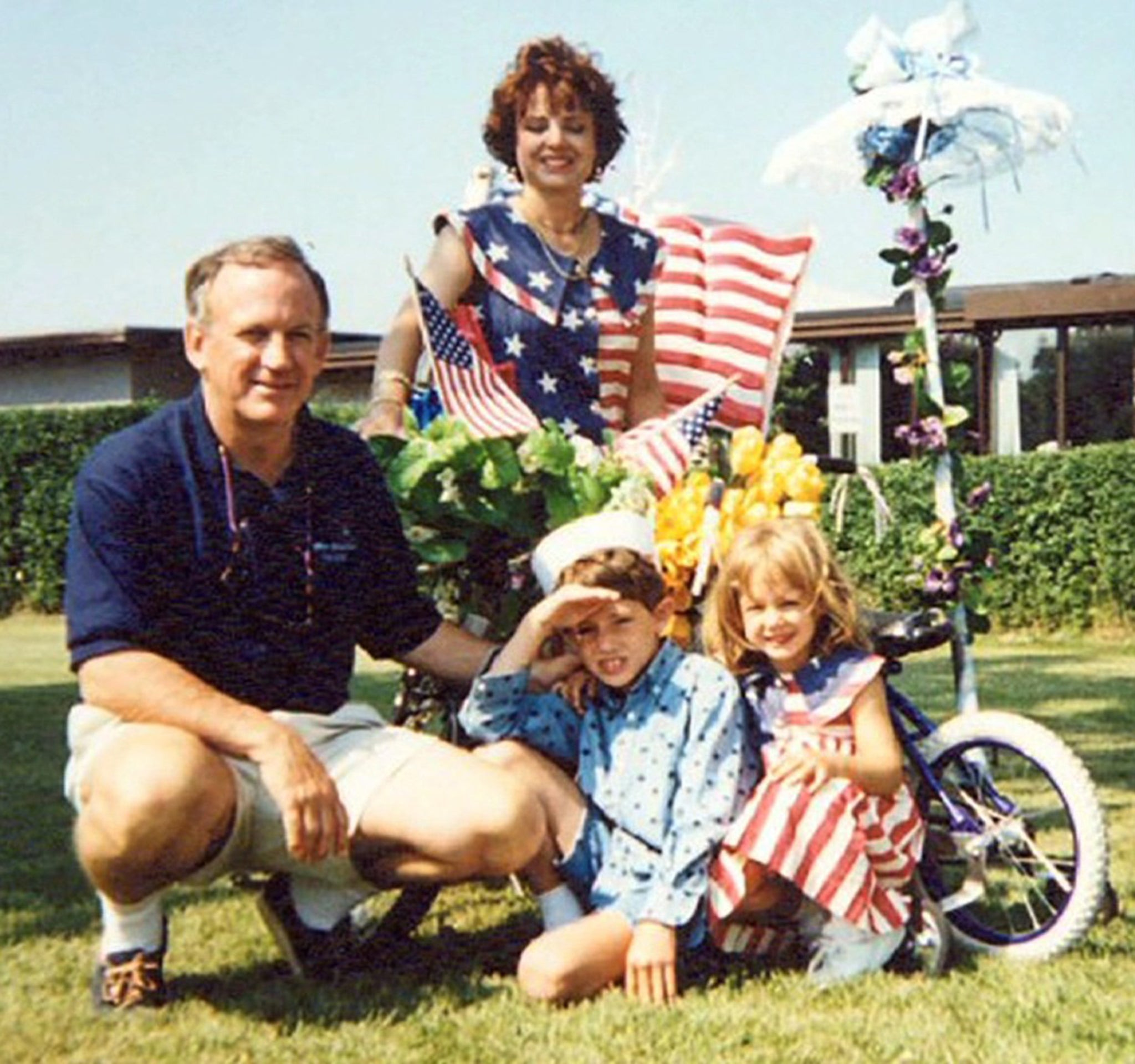 JonBenet, right, poses in a family photo with her father, John, mother, Patsy, and older brother, Burke