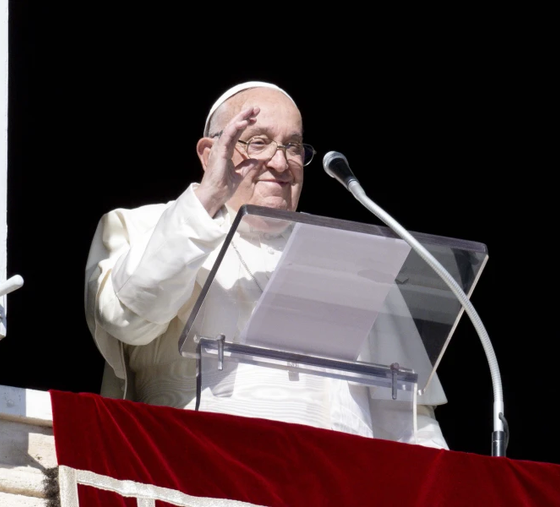 Pope Francis waves to pilgrims gathered in St. Peter’s Square from his window in the Apostolic Palace during his Angelus address on the Solemnity of All Saints, Nov. 1, 2024.