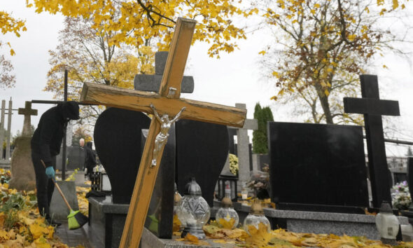 People prepare for All Saints' Day at the cemetery in Zakroczym, near Warsaw, Poland, Wednesday, Oct. 30, 2024. (AP Photo/Czarek Sokolowski)