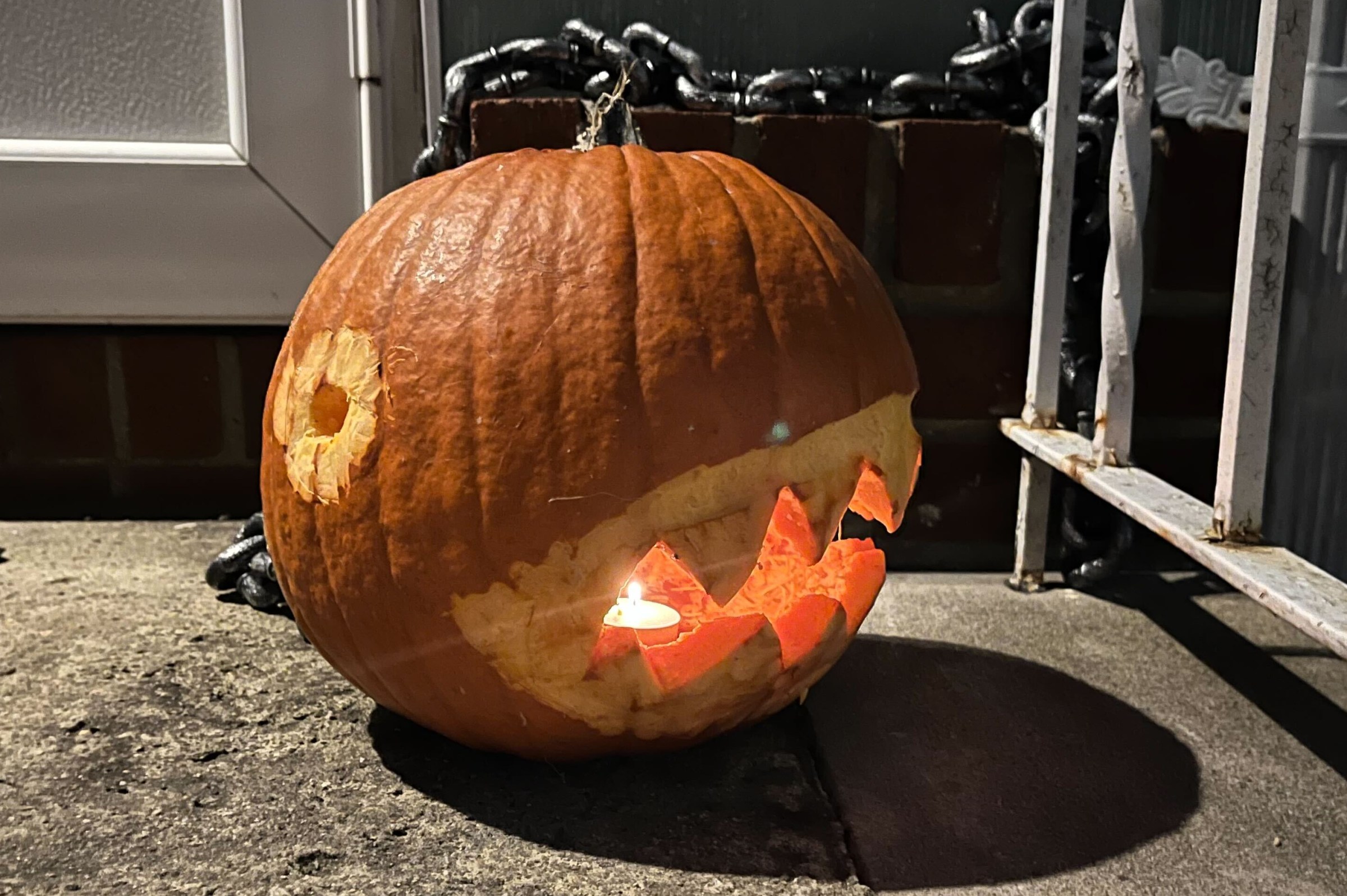 A jack-o-lantern with its face carved with spikey teeth, and eyes gouged onto it s surface to look like a Chain Chomp from Mario Bros. games.