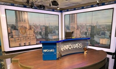 The Infowars set, featuring a large desk with the Infowars logo prominently displayed.