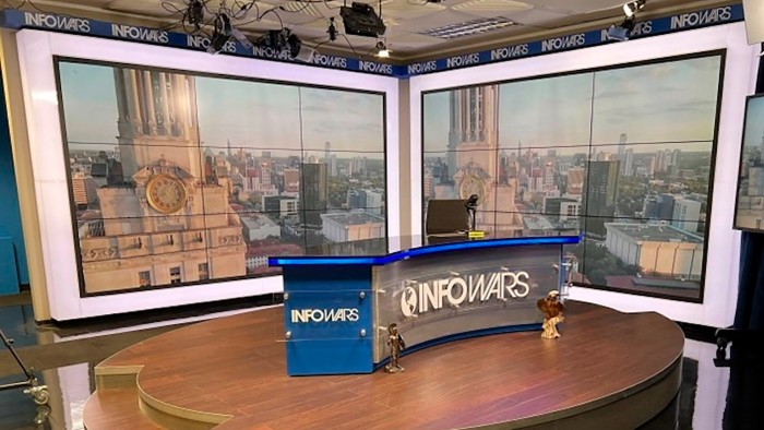 The Infowars set, featuring a large desk with the Infowars logo prominently displayed.