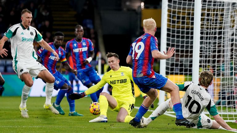 Anthony Gordon's cross is turned into the Crystal Palace net by Marc Guehi