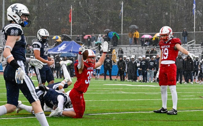 Natick senior Jack Showstead celebrates a touchdown during the annual Thanksgiving Day football game against Natick at Memorial Field in Natick, Thursday, Nov. 28, 2024. Natick High School defeated Framingham High School 42-15.