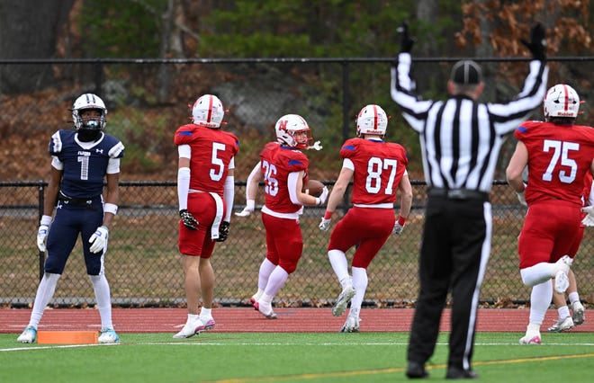 Natick senior Sam Hubbard (center) celebrates a touchdown with teammates senior James Perrier, senior Simon Pedrelli and junior Mike Whelan during the annual Thanksgiving Day football game at Memorial Field in Natick, Thursday, Nov. 28, 2024. Natick High School defeated Framingham High School 42-15.