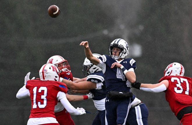 Framingham senior captain Matheus Silva passes the ball during the annual Thanksgiving Day football game against Natick at Memorial Field in Natick, Thursday, Nov. 28, 2024. Natick High School defeated Framingham High School 42-15.