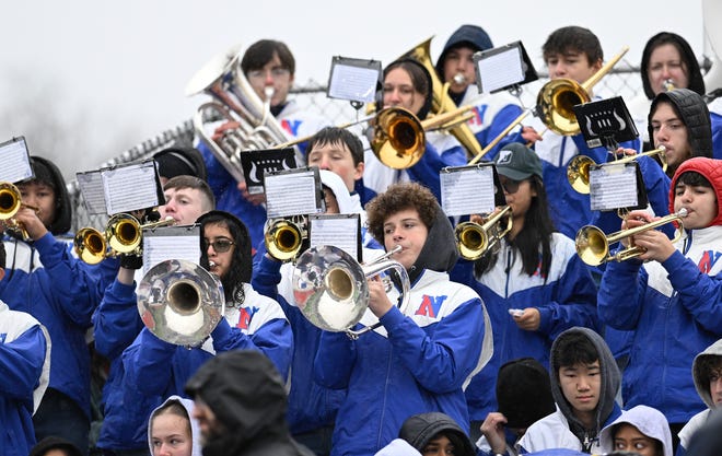 Members of the Natick marching band perform a song while in the stands during the annual Thanksgiving Day football game between Natick and Framingham at Memorial Field in Natick, Thursday, Nov. 28, 2024. Natick High School defeated Framingham High School 42-15.